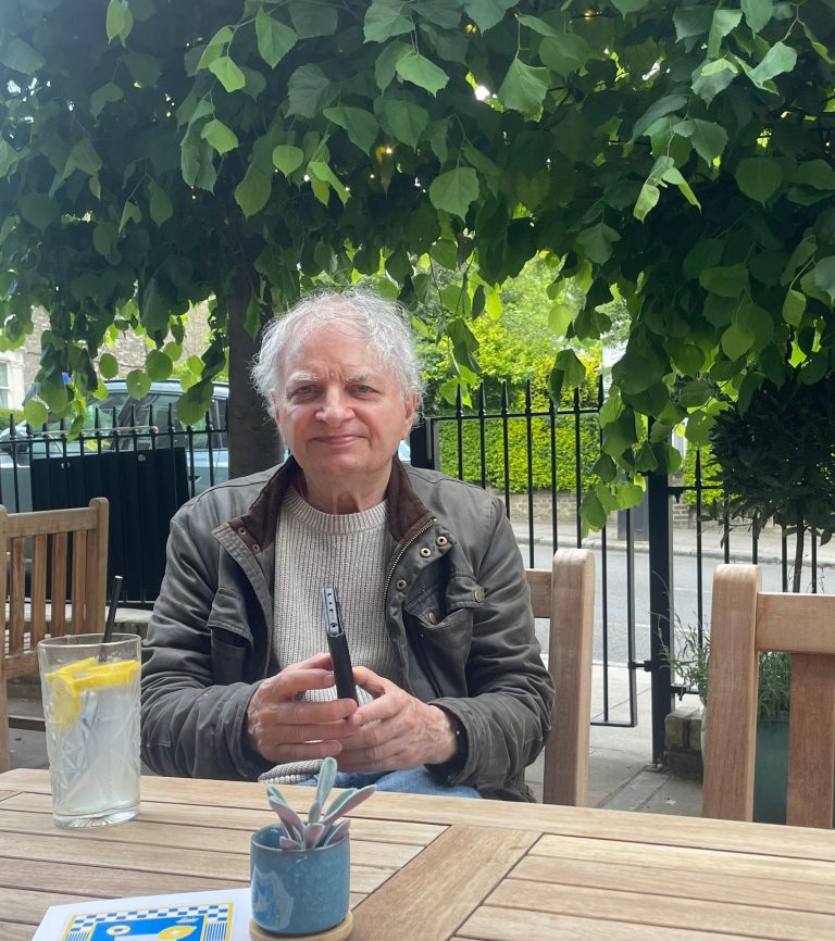 Picture of Clive Akass smiling at a table